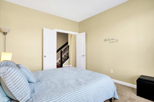 carpeted bedroom featuring baseboards