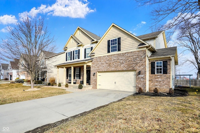 view of front of home with brick siding, concrete driveway, an attached garage, a front yard, and fence