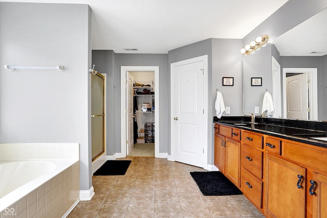 full bathroom featuring a garden tub, tile patterned flooring, vanity, visible vents, and a shower stall