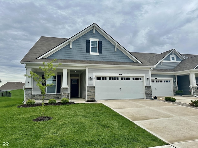50 Hovden Dr, Cicero, IN 46034 - craftsman-style home featuring covered porch, concrete driveway, a front yard, and stone siding
