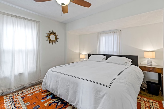 bedroom with ceiling fan and wood finished floors