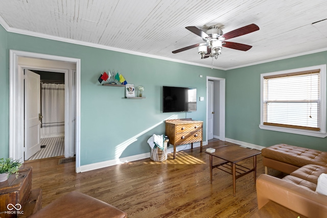 living room with a ceiling fan, baseboards, ornamental molding, and wood finished floors