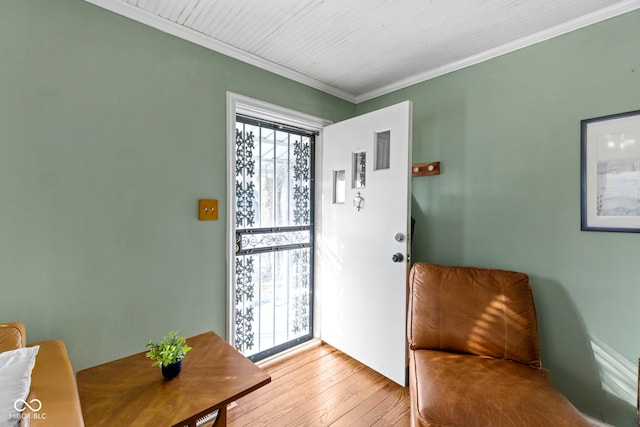 entrance foyer featuring ornamental molding and light wood finished floors