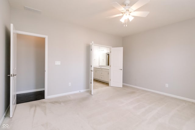 6117 Arctic Cir, Indianapolis, IN 46237 - unfurnished bedroom with light colored carpet, baseboards, ensuite bathroom, and ceiling fan