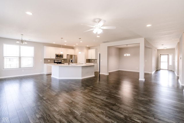 6117 Arctic Cir, Indianapolis, IN 46237 - unfurnished living room with a chandelier, recessed lighting, baseboards, dark wood-style floors, and ceiling fan