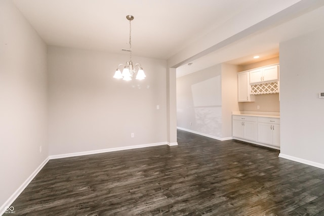 6117 Arctic Cir, Indianapolis, IN 46237 - spare room featuring dark wood-style floors, a chandelier, and baseboards