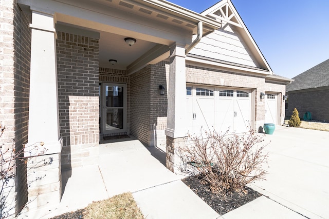 exterior space featuring concrete driveway, brick siding, and an attached garage