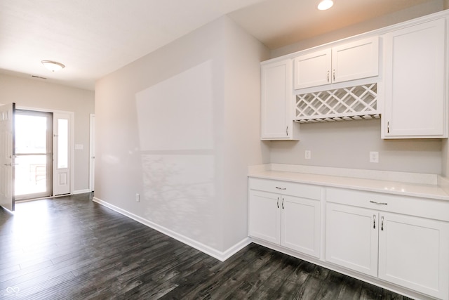 6117 Arctic Cir, Indianapolis, IN 46237 - kitchen featuring dark wood-style flooring, light countertops, white cabinets, and baseboards