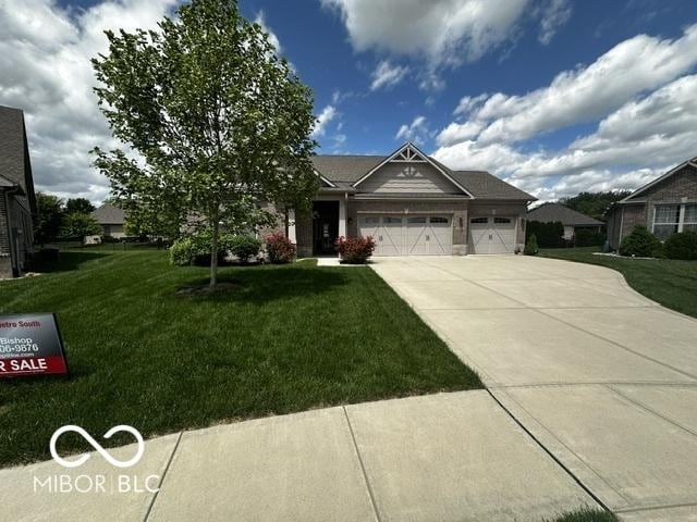 6117 Arctic Cir, Indianapolis, IN 46237 - view of front facade with a garage, a front yard, and concrete driveway