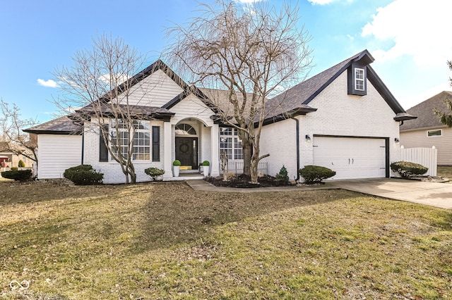 view of front of house featuring concrete driveway, brick siding, and a front yard