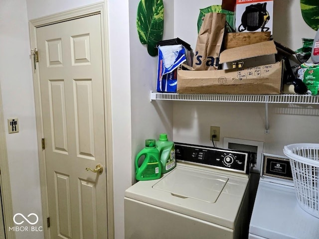 clothes washing area with washing machine and dryer and laundry area