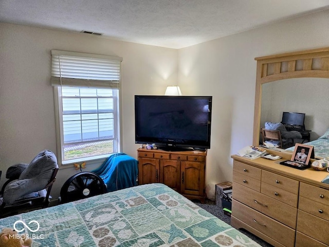 bedroom featuring visible vents and a textured ceiling