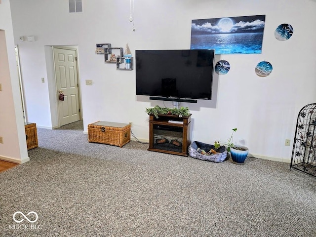 living area featuring baseboards and visible vents