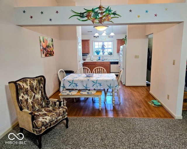 dining room featuring light wood-style flooring and baseboards