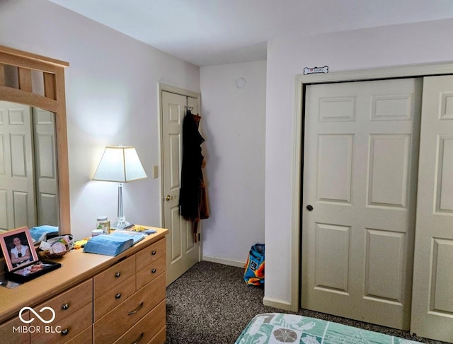 bedroom featuring dark colored carpet and baseboards