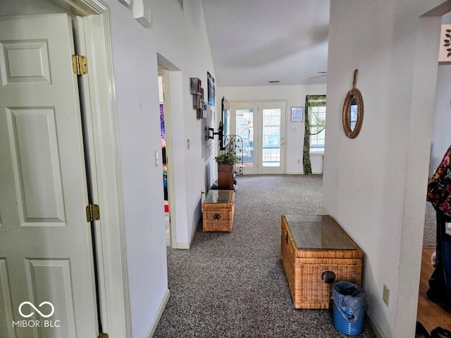 corridor featuring carpet and baseboards