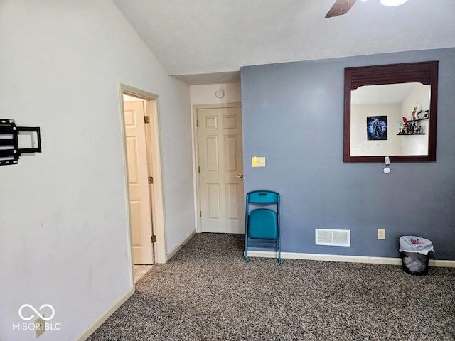 interior space featuring carpet, visible vents, vaulted ceiling, and baseboards