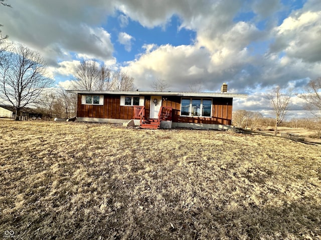 ranch-style home featuring a chimney