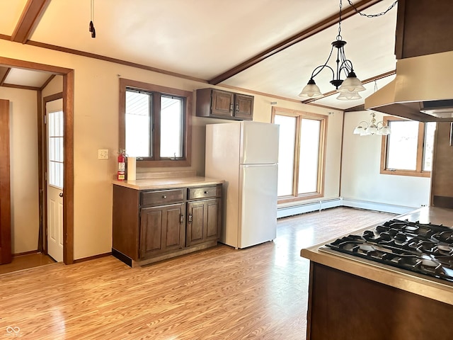 kitchen with light wood finished floors, exhaust hood, ornamental molding, and freestanding refrigerator