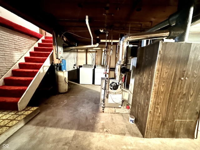 unfinished basement with stairs and washing machine and clothes dryer