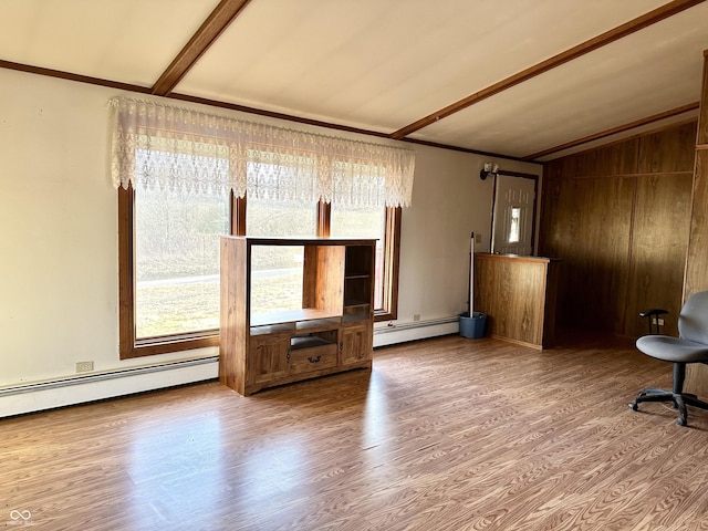 unfurnished living room featuring a baseboard heating unit, vaulted ceiling with beams, and wood finished floors