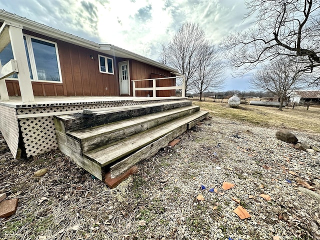 rear view of house featuring a wooden deck