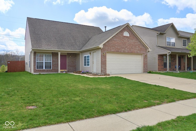 view of front of house featuring a garage, driveway, a front lawn, and brick siding