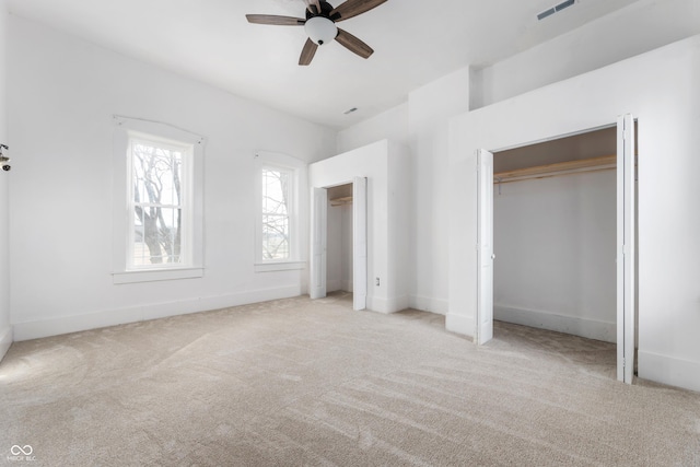 unfurnished bedroom with baseboards, visible vents, ceiling fan, and carpet flooring