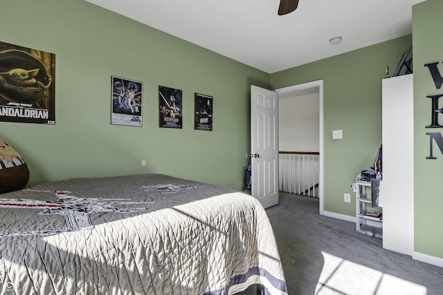 carpeted bedroom featuring a ceiling fan and baseboards