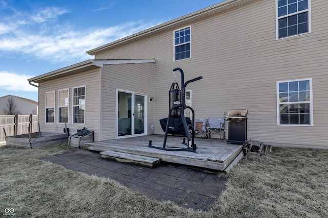 back of property featuring fence and a deck