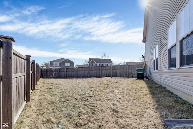 view of yard featuring a fenced backyard and central air condition unit