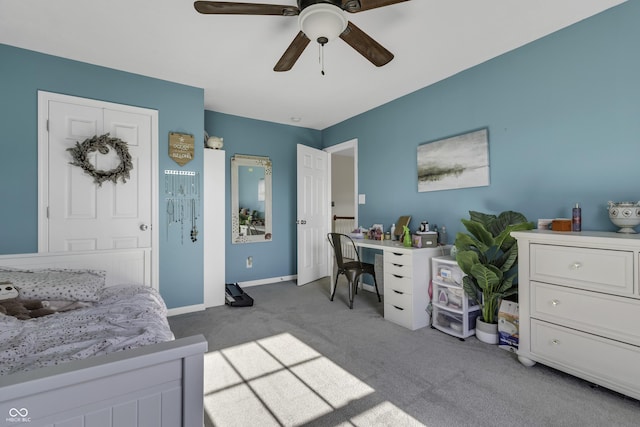 office area featuring a ceiling fan, baseboards, and carpet flooring