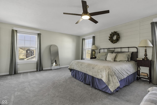 carpeted bedroom featuring a ceiling fan and baseboards