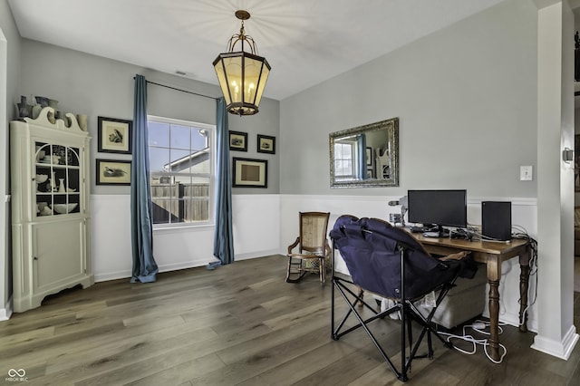 office featuring a chandelier, a wainscoted wall, a healthy amount of sunlight, and wood finished floors