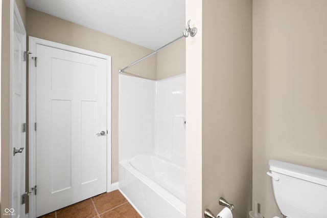 full bathroom with toilet, tile patterned flooring, and shower / washtub combination