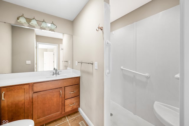 bathroom with visible vents, a stall shower, tile patterned flooring, and vanity