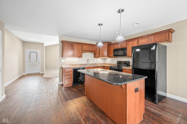 kitchen with a center island, brown cabinets, dark wood finished floors, and black appliances