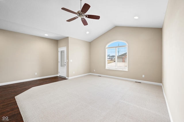 unfurnished room with a ceiling fan, lofted ceiling, visible vents, and baseboards