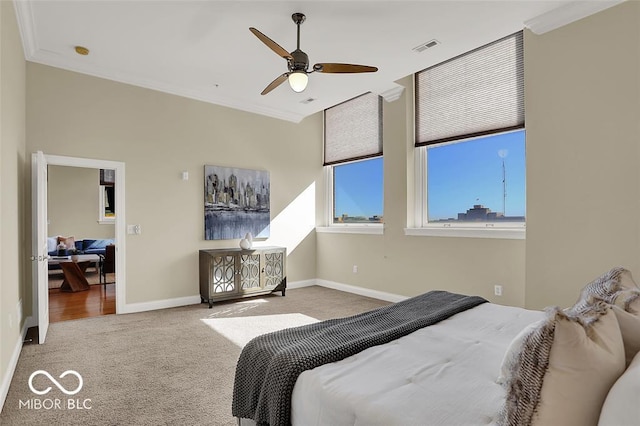 bedroom with baseboards, visible vents, a ceiling fan, carpet, and crown molding