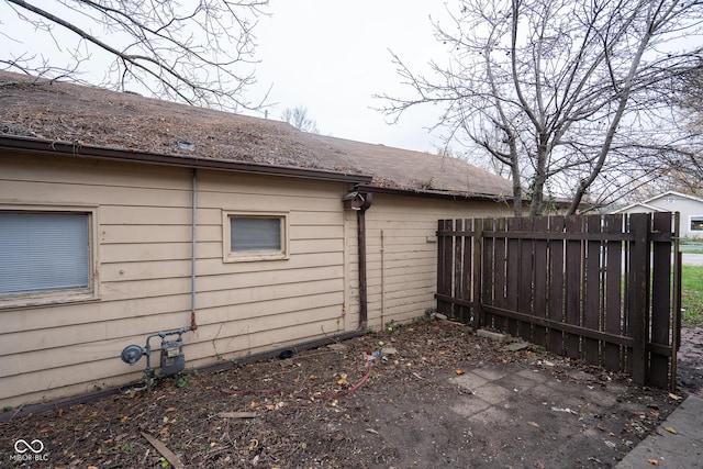 view of home's exterior with fence