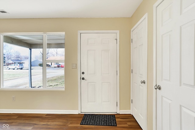 entryway featuring dark wood-style flooring, visible vents, and baseboards