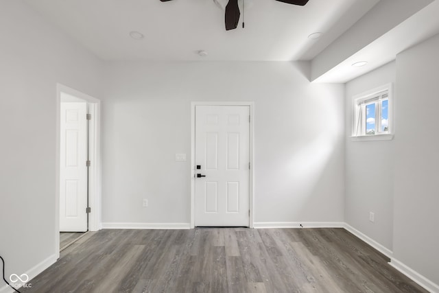 unfurnished room featuring a ceiling fan, baseboards, and wood finished floors