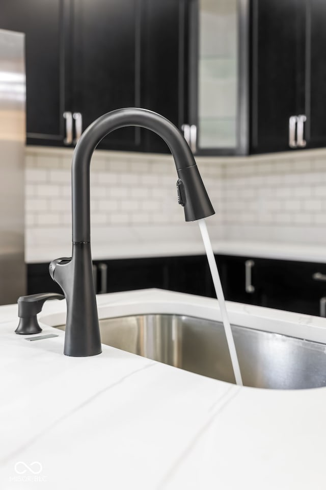 room details featuring dark cabinetry and a sink