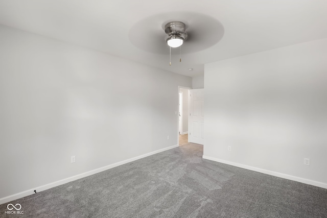 carpeted empty room with a ceiling fan and baseboards