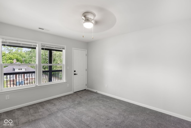 unfurnished room with baseboards, visible vents, ceiling fan, and carpet flooring