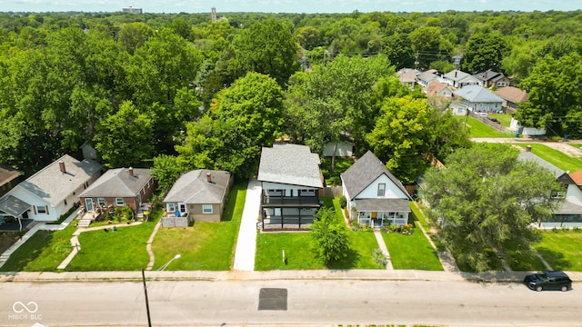 drone / aerial view with a residential view and a view of trees