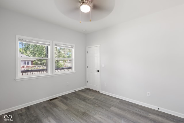 spare room with visible vents, baseboards, ceiling fan, and wood finished floors