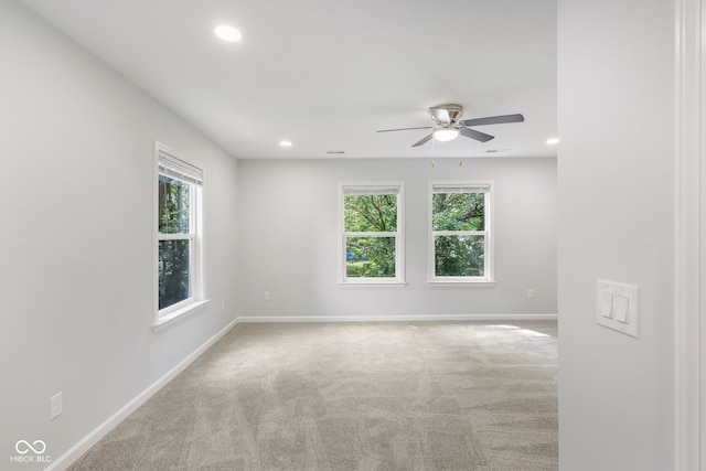 carpeted empty room featuring visible vents, recessed lighting, a ceiling fan, and baseboards