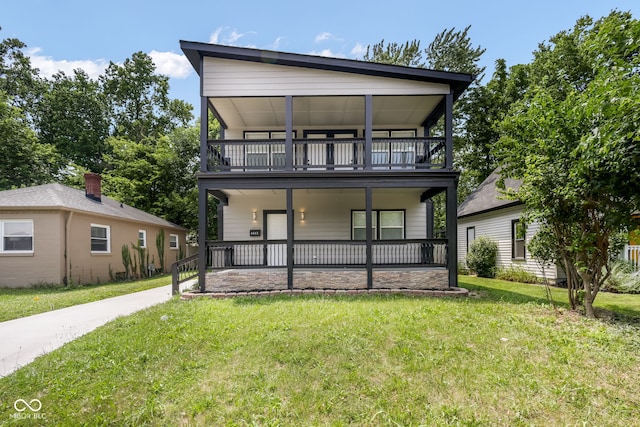 view of front of home featuring a porch, a front yard, and a balcony