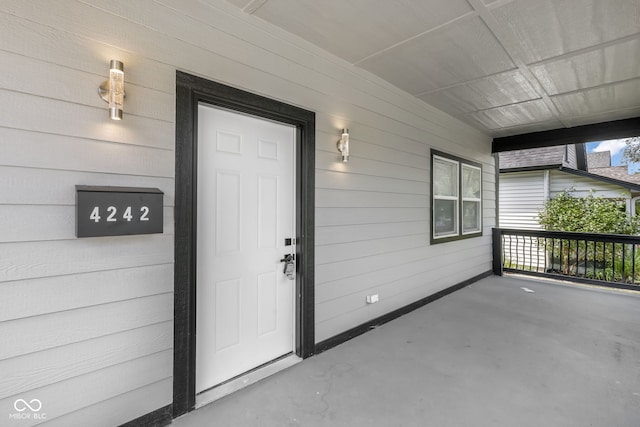 doorway to property featuring a porch